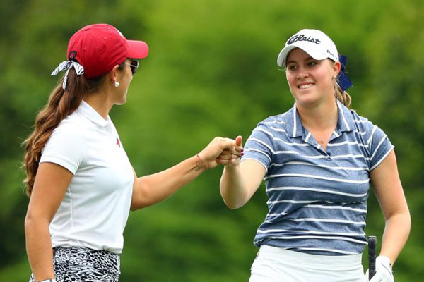 Jennifer Kupcho (left) and Maria Fassi (right) fist bump on their way to the 12th green during the Augusta National Women's Amateur. (photo courtesy of Rob Schumacher, USA Today Sports)