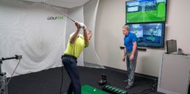 A man in the middle of a lesson at GOLFTEC.