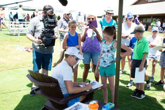 Kupcho signs an autograph for one of her many young fans.