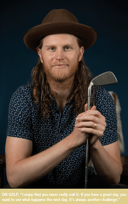 Wesley Schultz of The Lumineers poses with a golf club. 