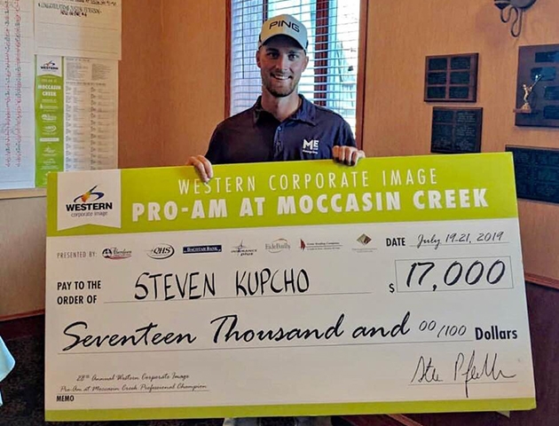 Steven Kupcho holds his first winner's check in South Dakota.