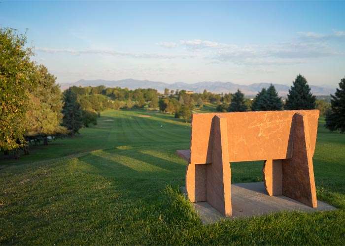A lone bench on the tee box at Willis Case Golf Course in Denver near the 5390' Community.