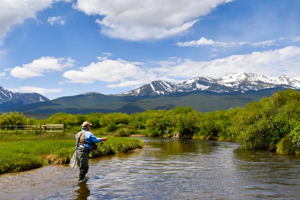 Charles Duke casts a line into the river in Colorado.