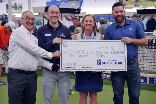 The PGA TOUR Superstore presents The First Tee of Green Valley Ranch with a $10,000 check.