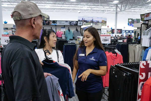 Shoppers receiving attention from an employee at the PGA TOUR Superstore in Westminster, Colorado.
