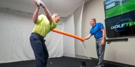 GOLFTEC teacher helping a student