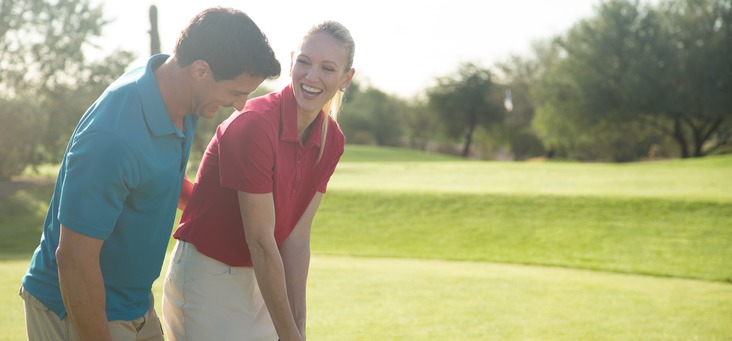 A couple enjoy their time playing golf