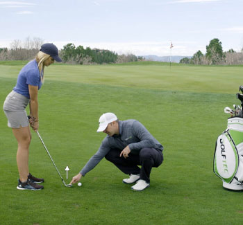 GOLFTEC instructor helps teach how to chip onto the green