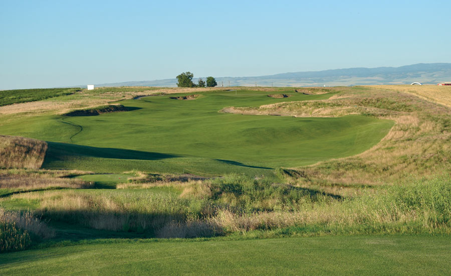 PENULTIMATE PIN: From a downhill tee shot, Wine Valley’s par-4 17th winds uphill to a tiered green guarded left and right with bunkers.