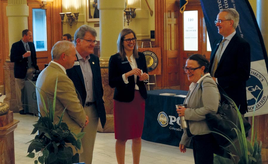 CONSENSUS BUILDER: Cassell chats with Eddie Ainsworth of the Colorado Golf Coalition and legislators at the annual Golf Day at the Capitol.