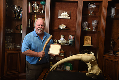 Craig Stadler Holding an Enormous, Mammal Tusk.