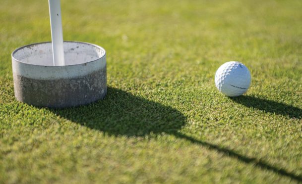 A golf hole is raised to prevent the spread of COVID-19
