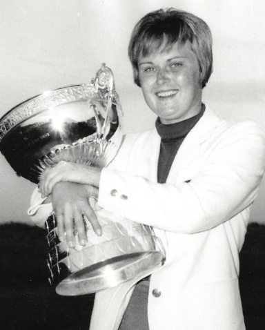 Her and the trophy after winning the competition—part of her dominating year in amateur golf (left).