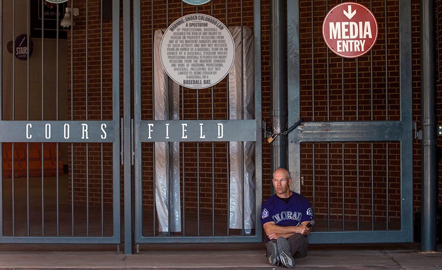 Drew Goodman sitting out from of Coors Field