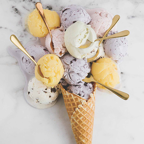 Blueberry, Strawberry, Vegan Avocado Coconut, Mango Sorbet and Mint Cocoa Nib Chip scoops with a handmade waffle cone from Sundae. PHOTOGRAPH BY REBECCA STUMPF/SUNDAE