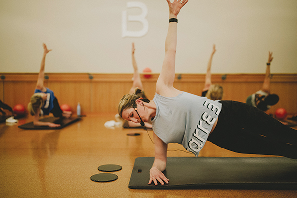 A barre 3 instructor strikes a pose