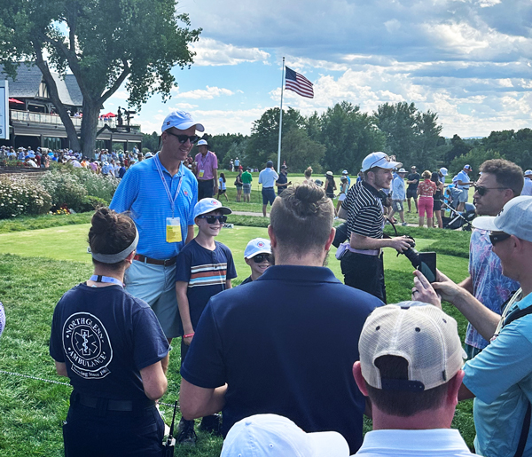 Fans on the 10th tee at Cherry Hills swarm to get their photo taken with and U.S. Amateur Honorary Chairman (and Hall of Fame quarterback) Peyton Manning. (Photo by Jon Rizzi)